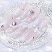 Custom japanese handmade press-on nail set by Kei Atelier, featuring a white lace and light baby pink design with a lattice design, angel wings, lace french tips, white and pink ribbon bow charms, and rhinestones, jirai ryousangata coquette aethetic